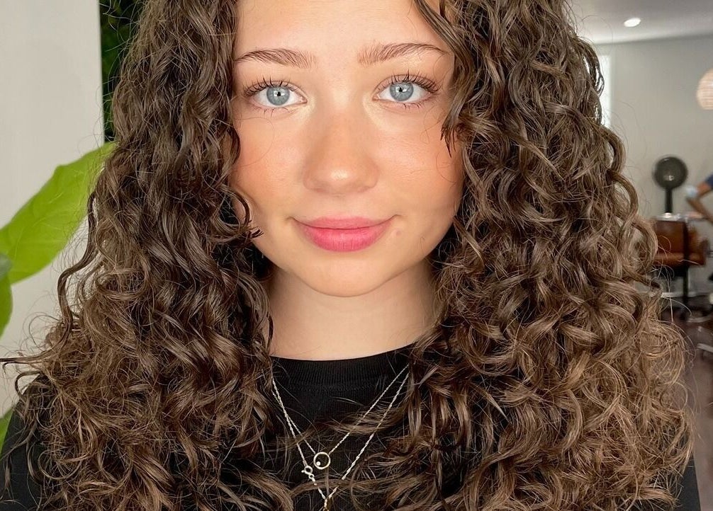 Woman with styled curly hair at The Curl Lounge in Toronto, Ontario, CA.