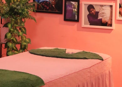 Cozy massage room at PMC Beauty & Herbs, Shah Alam, Selangor, MY with green decor and framed photos.