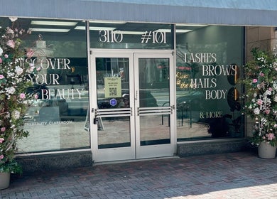 Entrance to The Beauty Clarendon Nails and Body Services, adorned with floral decor in Arlington, Virginia, US.