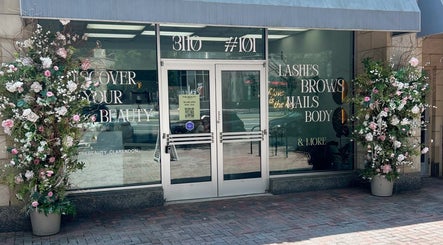 Entrance to The Beauty Clarendon Nails and Body Services, adorned with floral decor in Arlington, Virginia, US.