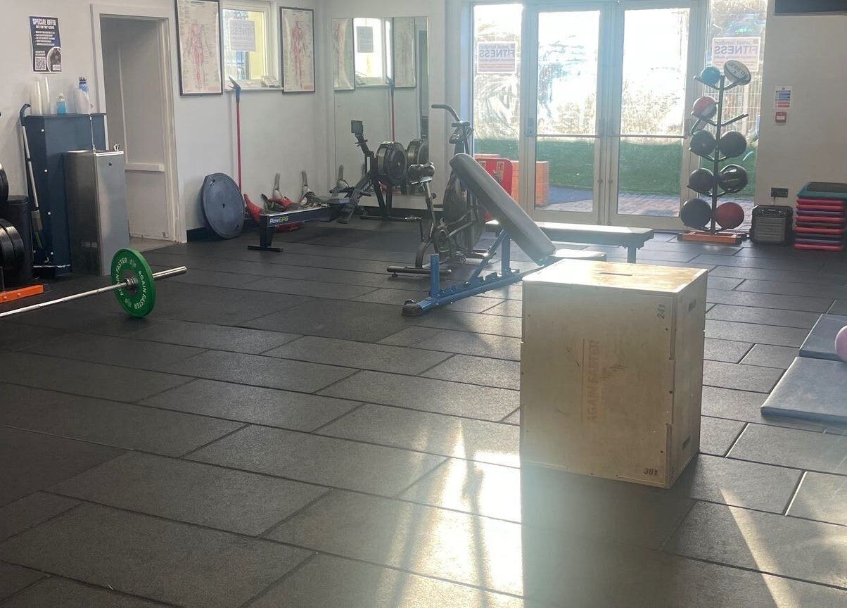 Spacious gym at Carol Redman Personal Training, London, England, GB, with fitness equipment and natural lighting.
