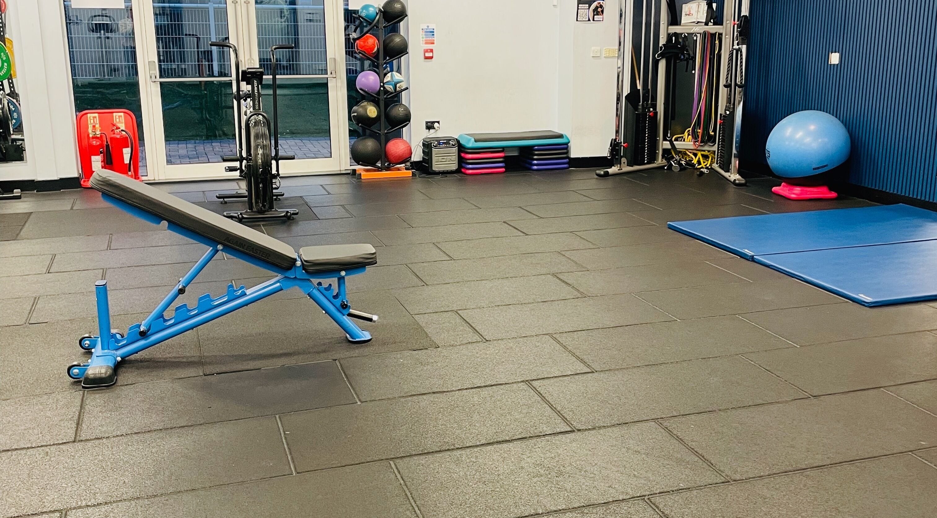 Modern gym interior at Carol Redman Personal Training, London, England, GB with equipment and exercise mats.