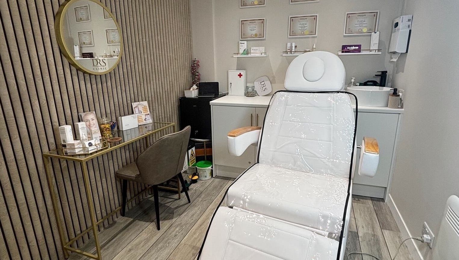 Modern treatment room at DR.S Clinic, Prestwich, England, GB with reclining chair and minimal decor.