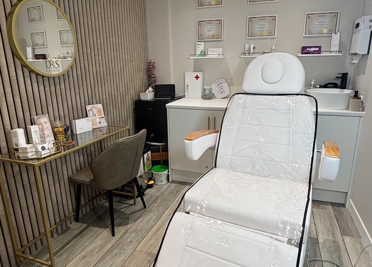 Modern treatment room at DR.S Clinic, Prestwich, England, GB with reclining chair and minimal decor.