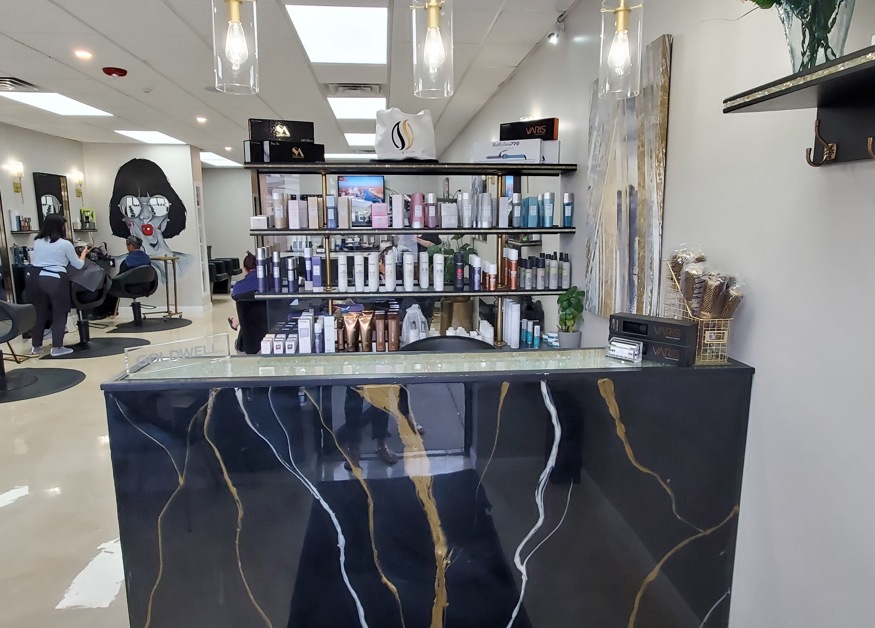Elegant interior at Salon Secora in Saugus, Massachusetts, US, featuring modern styling stations and product display.