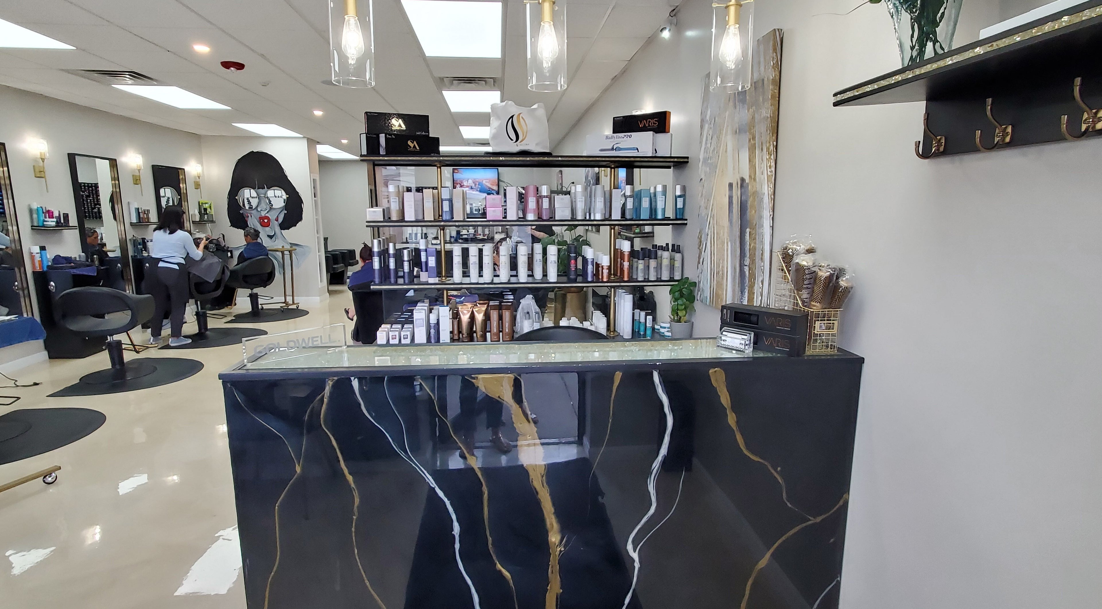 Elegant interior at Salon Secora in Saugus, Massachusetts, US, featuring modern styling stations and product display.