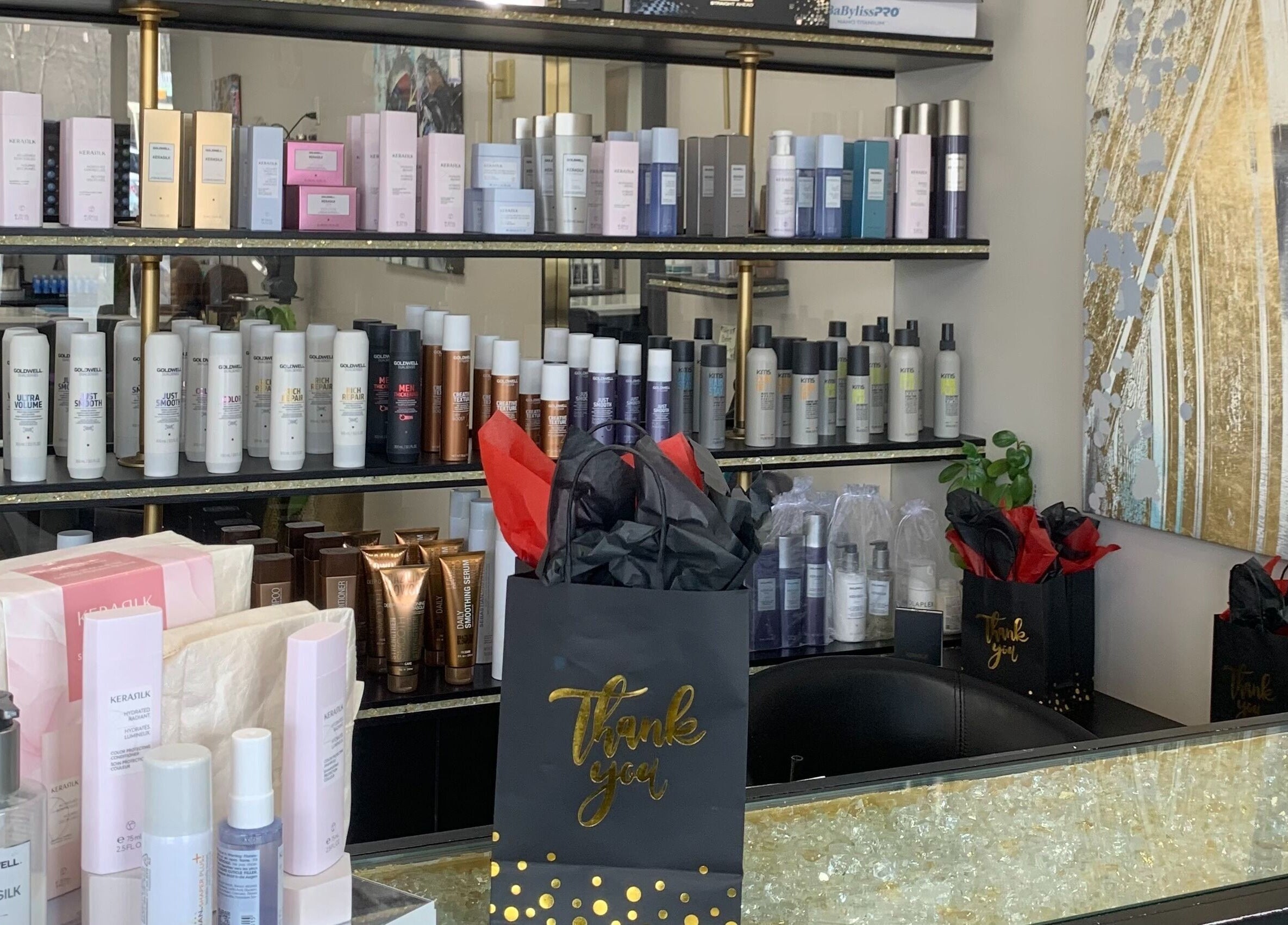 Shelf of premium hair products at Salon Secora in Saugus, Massachusetts, US, with elegant decor.
