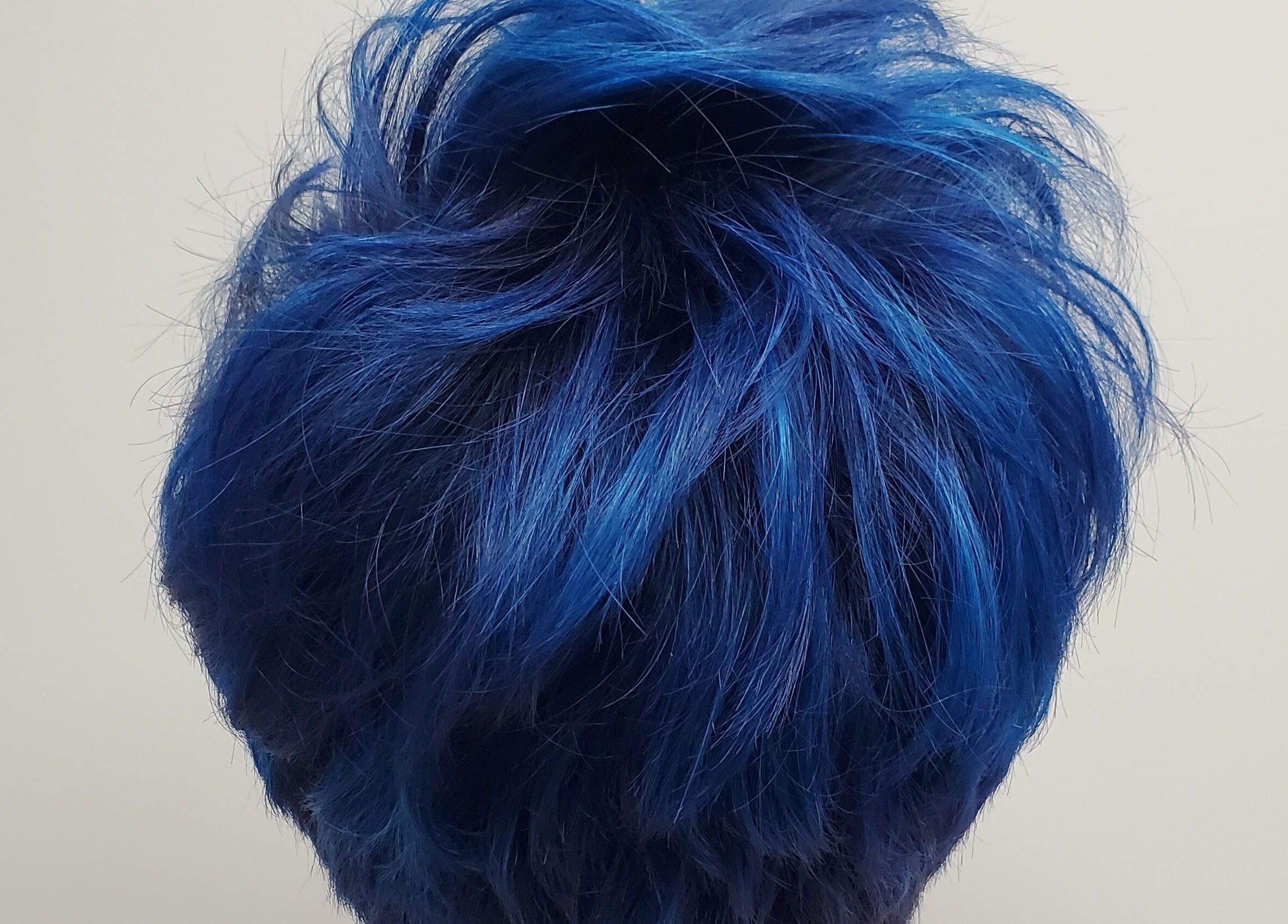 Dynamic blue hairstyle at Salon Secora in Saugus, Massachusetts, US, showcasing expert color work.