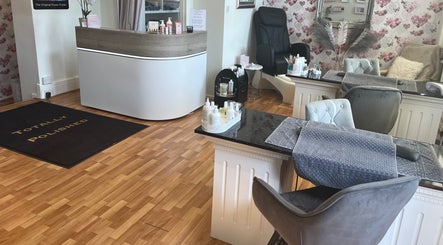 Interior of Totally Polished Beauty & Nails in Drighlington, England, GB with elegant chairs and decor.