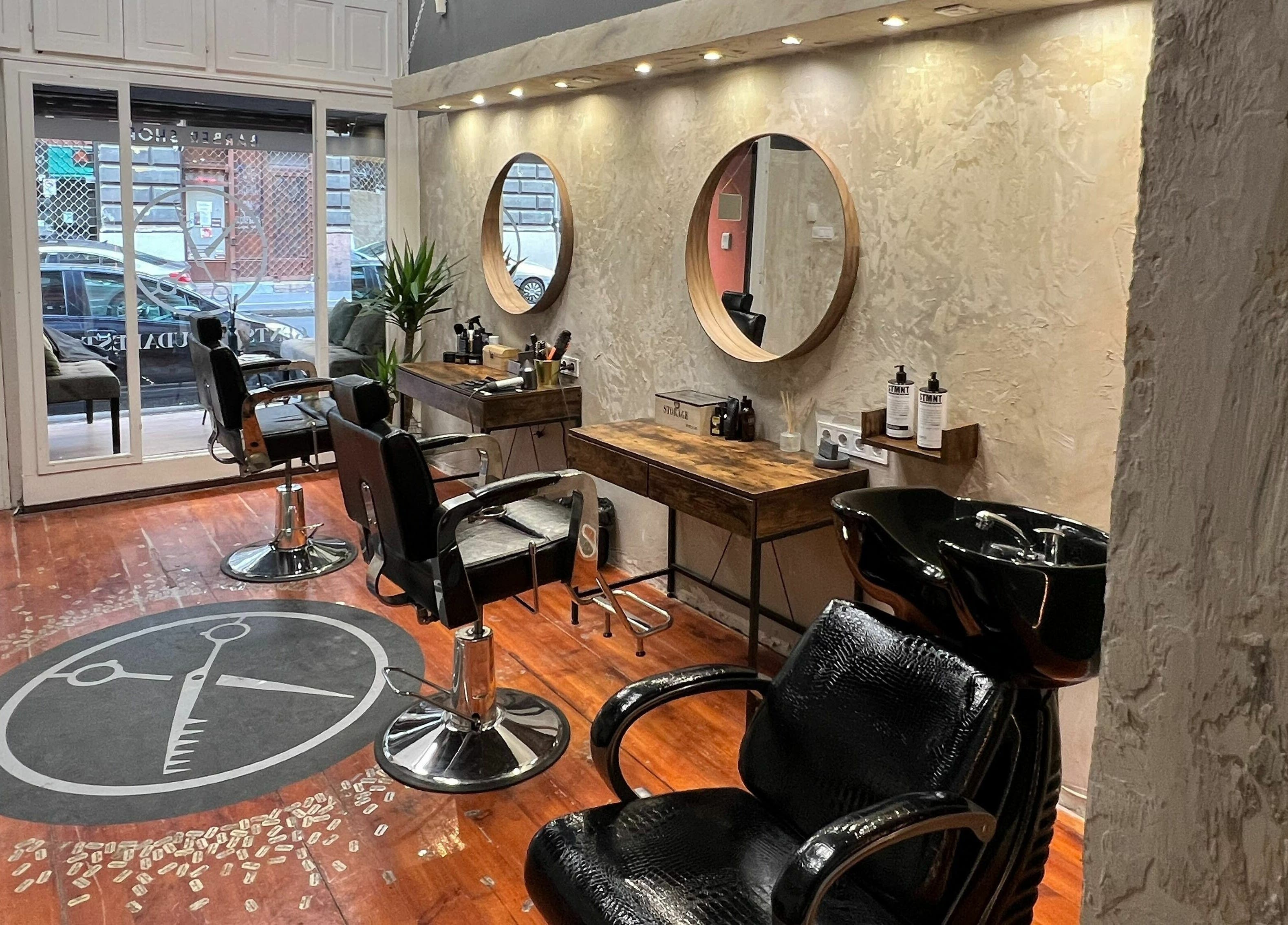 Chic interior of Gents of Budapest (VI.ker) salon, Budapest, Magyar, HU, with modern barber chairs and mirrors.