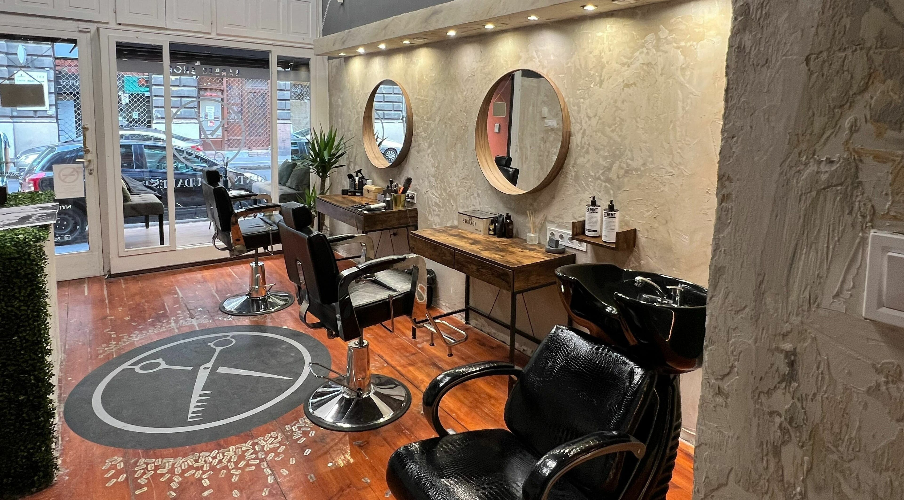 Chic interior of Gents of Budapest (VI.ker) salon, Budapest, Magyar, HU, with modern barber chairs and mirrors.
