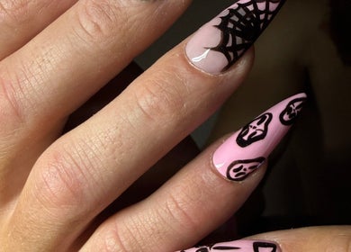 Gothic nail art at Luna-Luxe Beauty Bar, Geelong, Victoria, AU featuring pink polish with black web and mask designs.