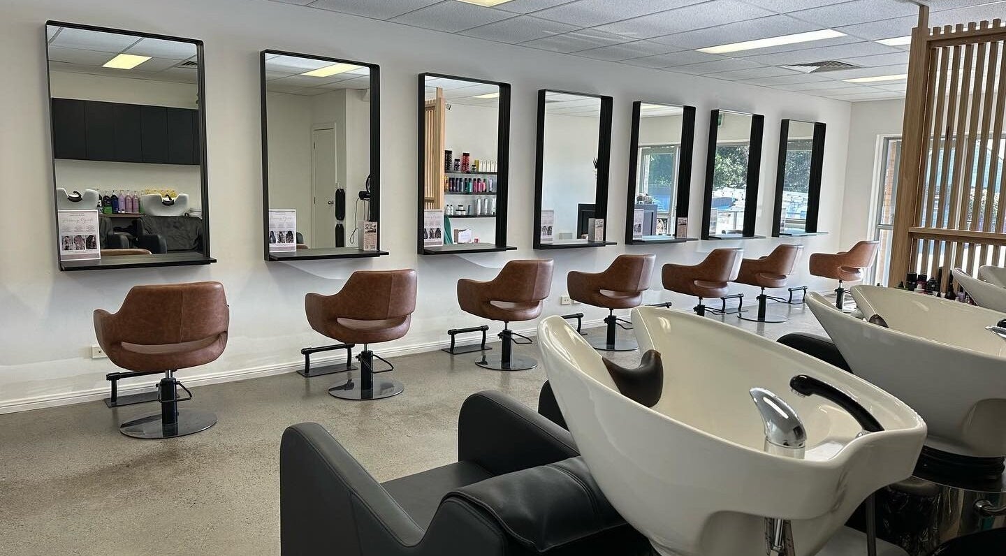 Chic interior of Kimberley Jayne Hair & Makeup in East Maitland, New South Wales, AU, featuring sleek salon stations.