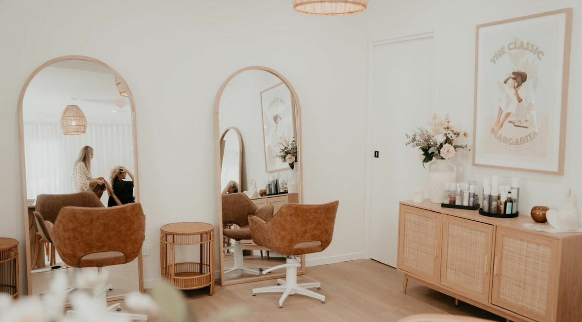 Stylish salon interior at Bombshell Hair Noosa in Cooroy, Queensland, AU showcasing modern decor and styling area.