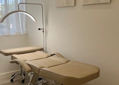 Relaxing spa room at Haus Of Allure, Clontarf, Queensland, AU, featuring a plush massage table and ambient lighting.
