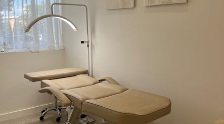 Relaxing spa room at Haus Of Allure, Clontarf, Queensland, AU, featuring a plush massage table and ambient lighting.