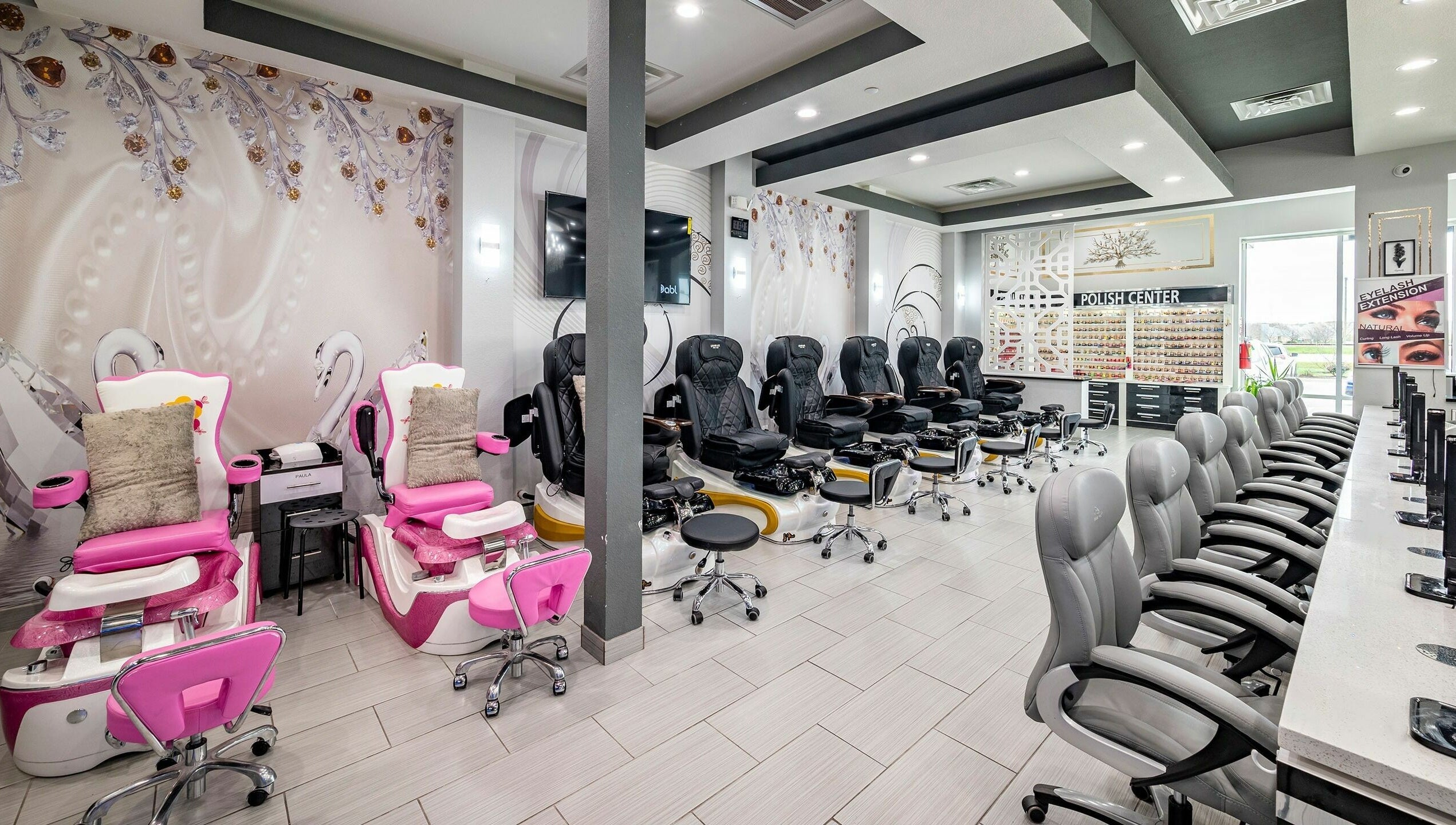 Interior of GrandLux Nails Spa, Round Rock, Texas, US with elegant chairs and decor.