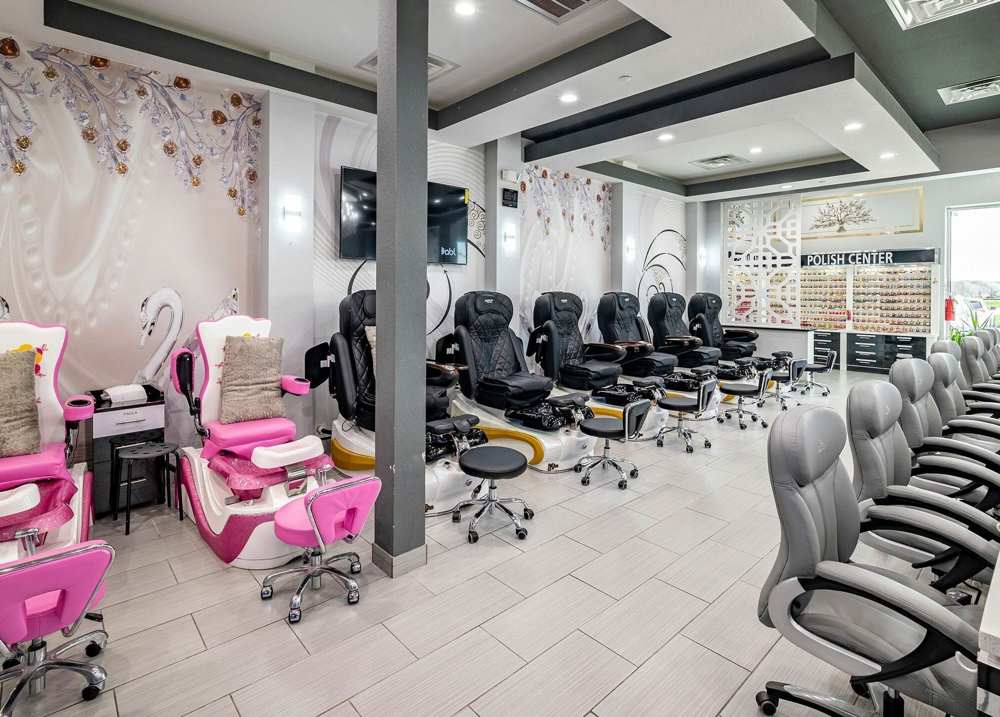 Interior of GrandLux Nails Spa, Round Rock, Texas, US with elegant chairs and decor.