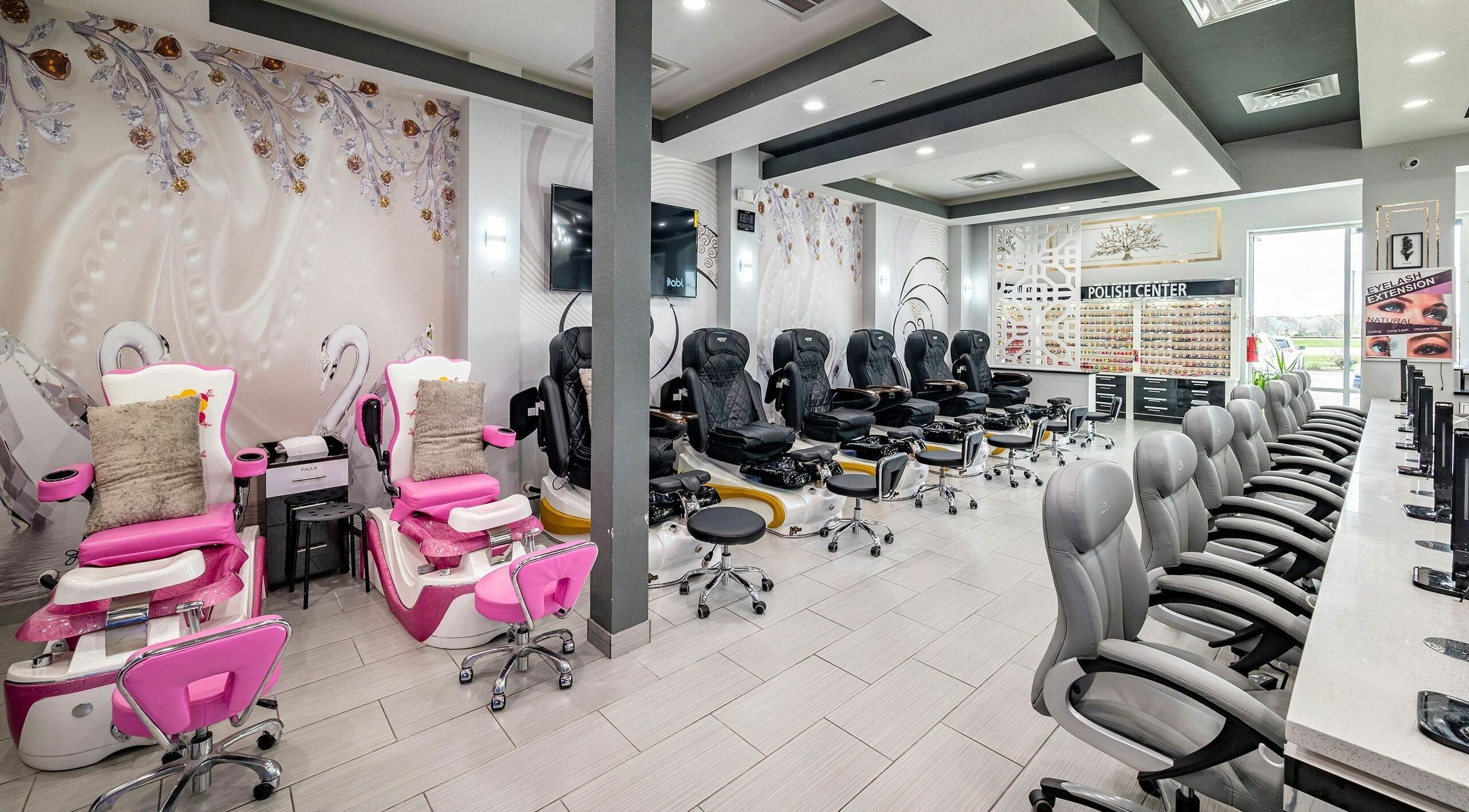 Interior of GrandLux Nails Spa, Round Rock, Texas, US with elegant chairs and decor.