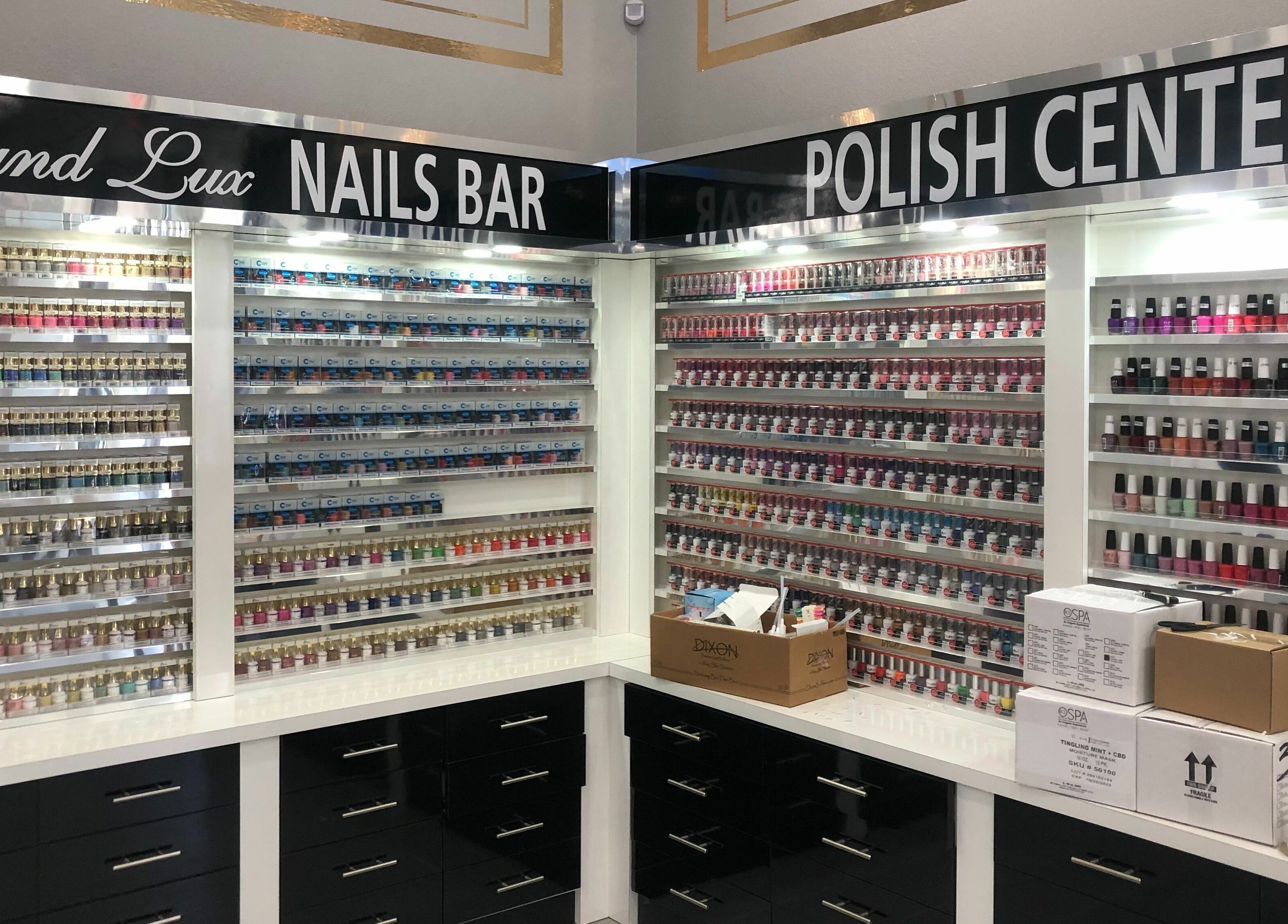 Vibrant nail polish wall at GrandLux Nails Spa, Round Rock, Texas, US, showcasing diverse color selection.