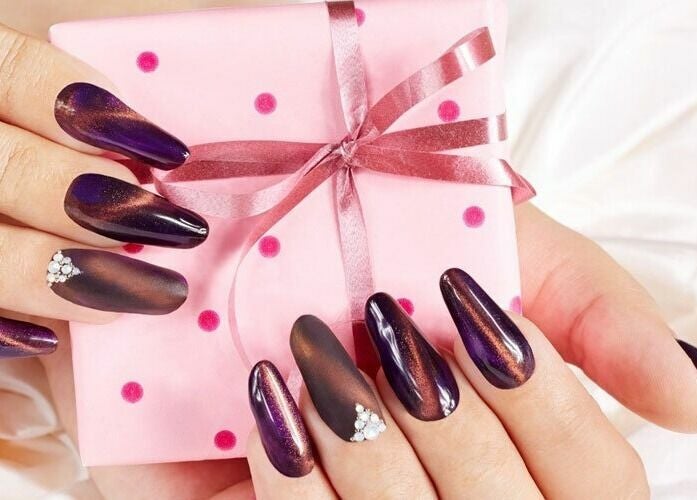 Elegant nail art with deep purple hues at GrandLux Nails Spa, Round Rock, Texas, US.