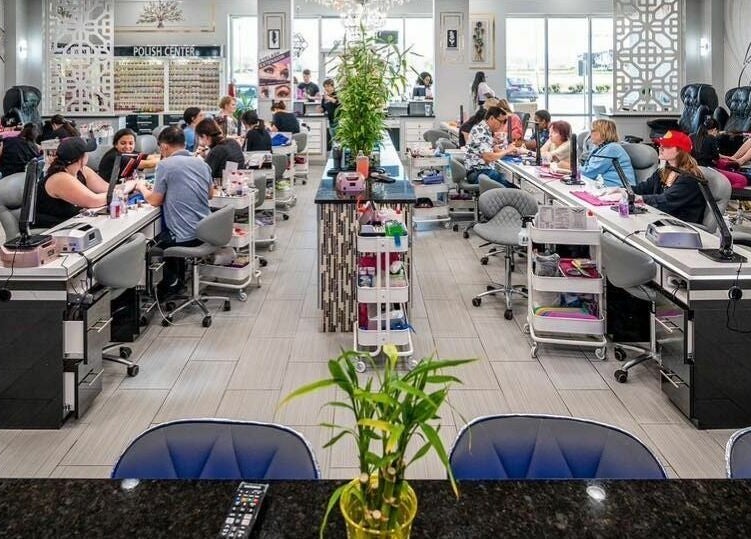 GrandLux Nails Spa in Round Rock, Texas, US, showcasing busy manicure stations in a modern, elegant setting.
