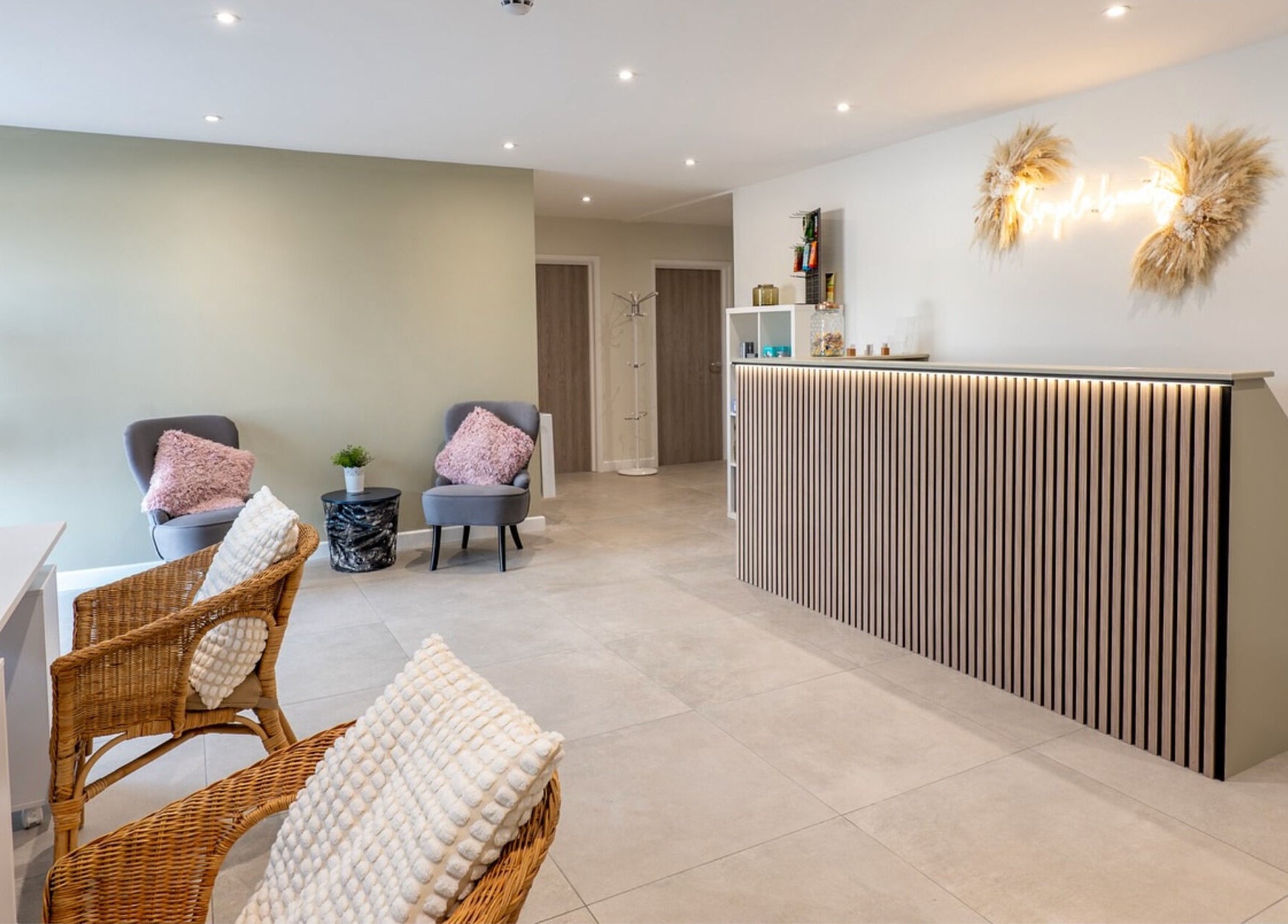 Modern reception of Simple Beauty, Cullompton, England, GB with stylish seating and decor.