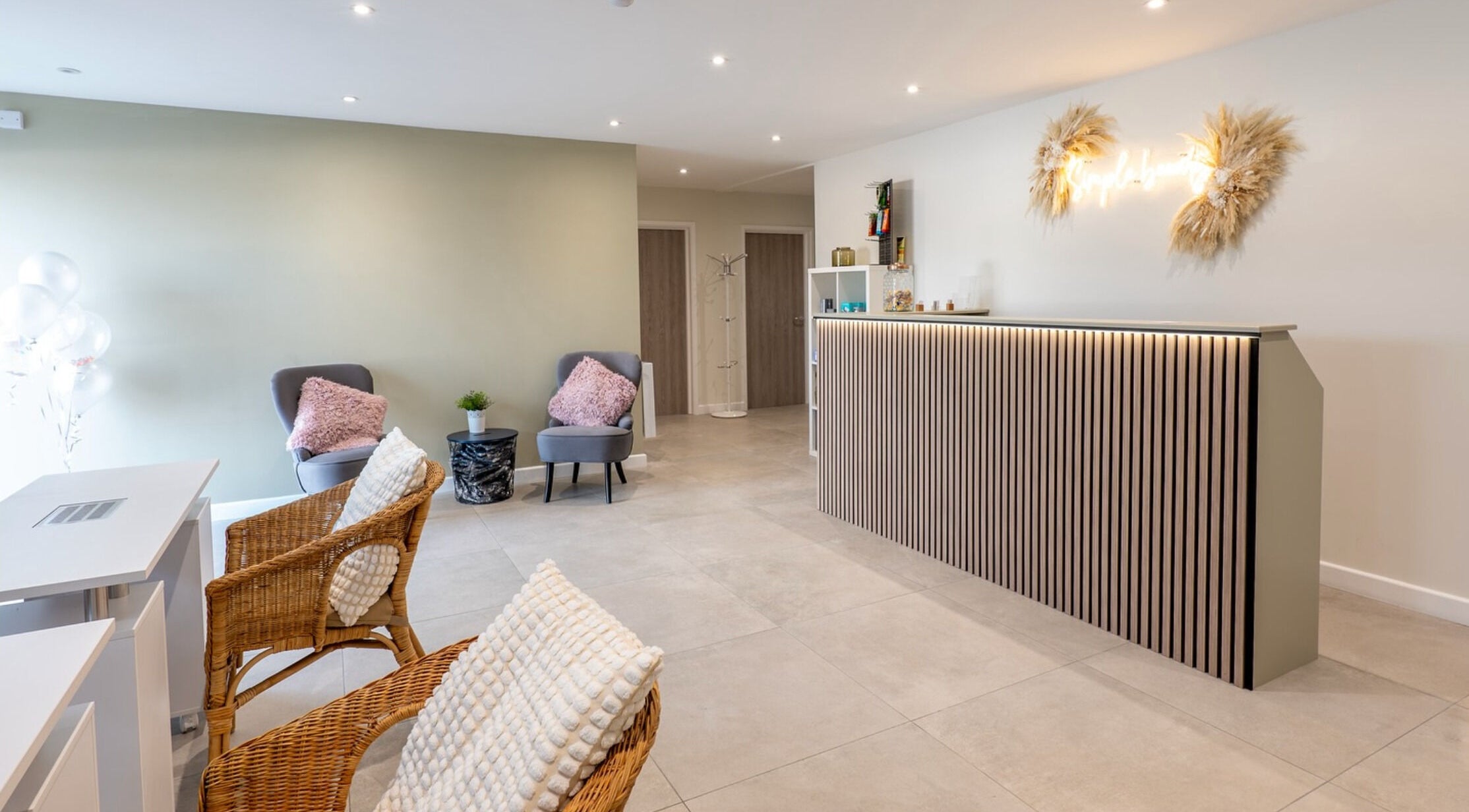 Modern reception of Simple Beauty, Cullompton, England, GB with stylish seating and decor.