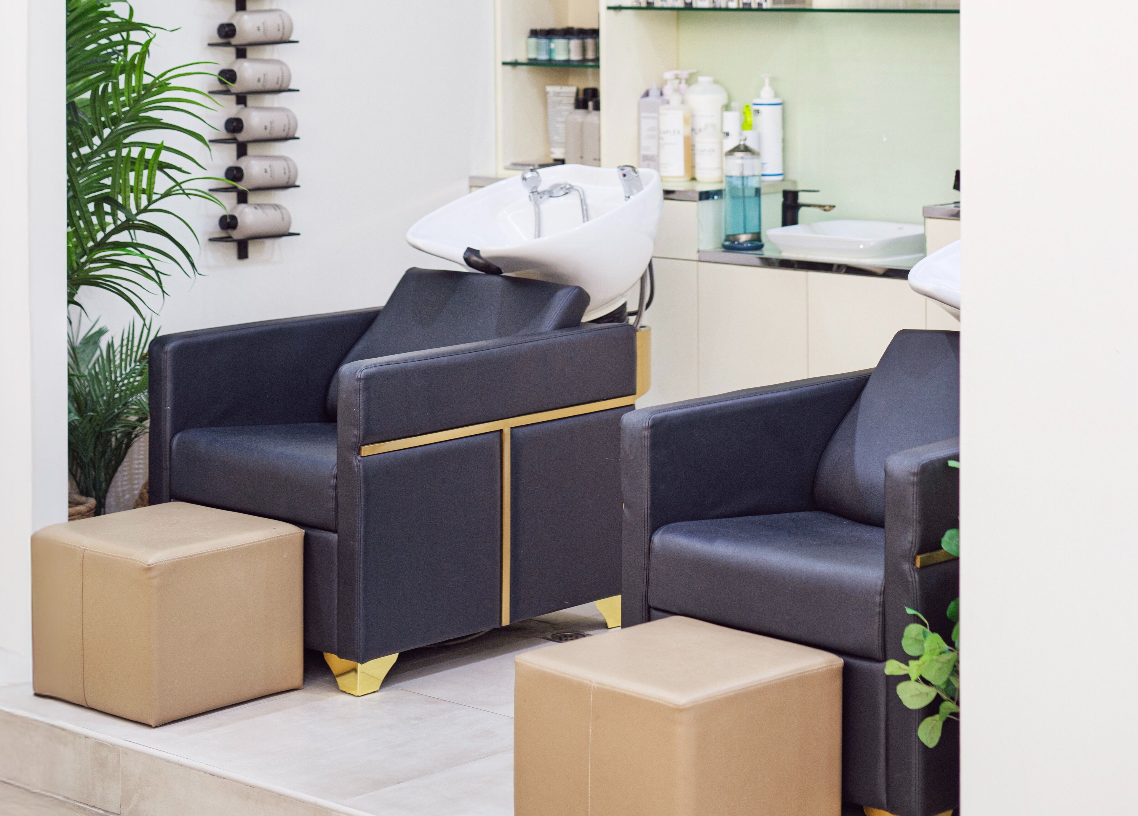 Chic salon washing area at Soak Salon, Dubai, AE. Features plush chairs and modern decor for relaxation.