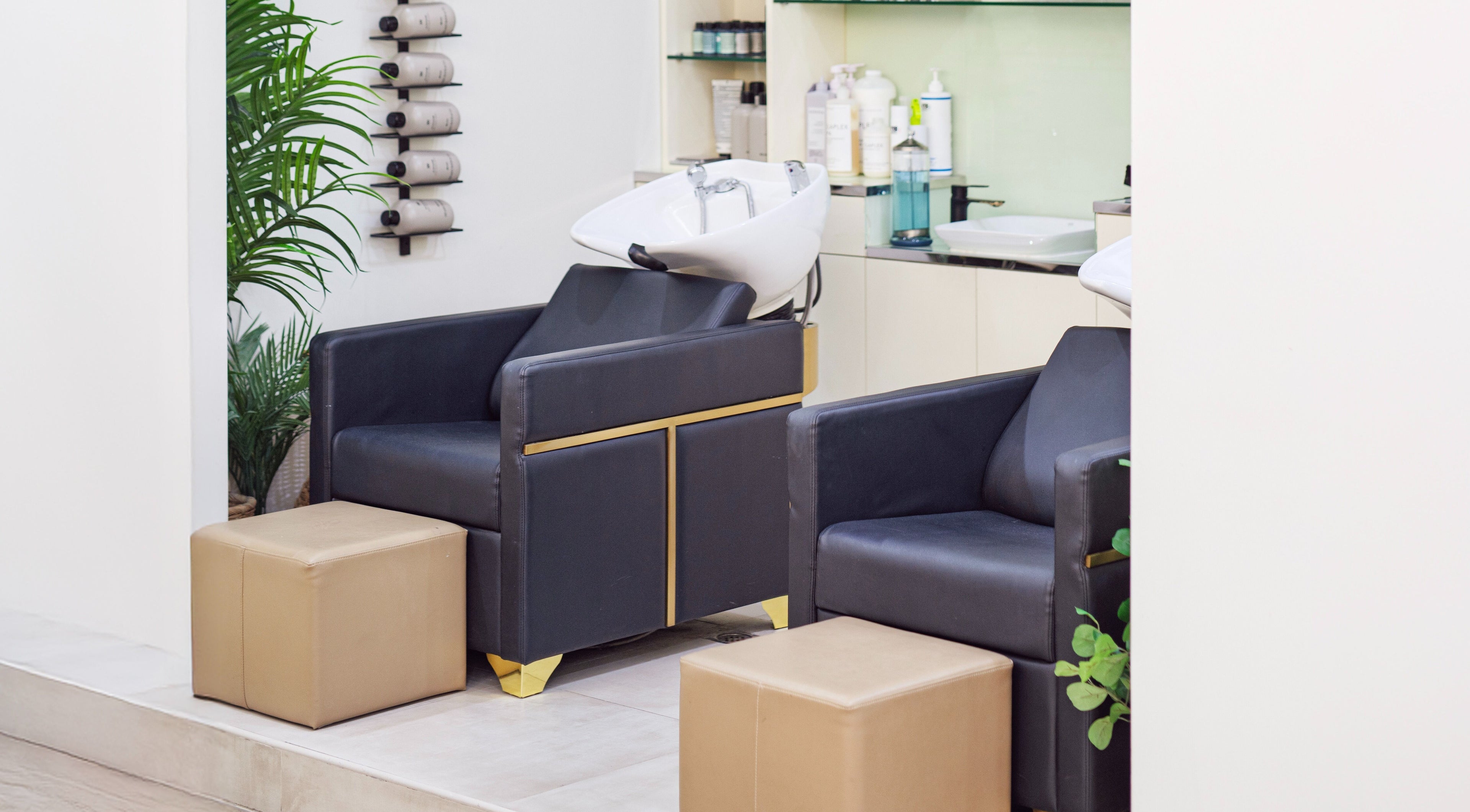 Chic salon washing area at Soak Salon, Dubai, AE. Features plush chairs and modern decor for relaxation.