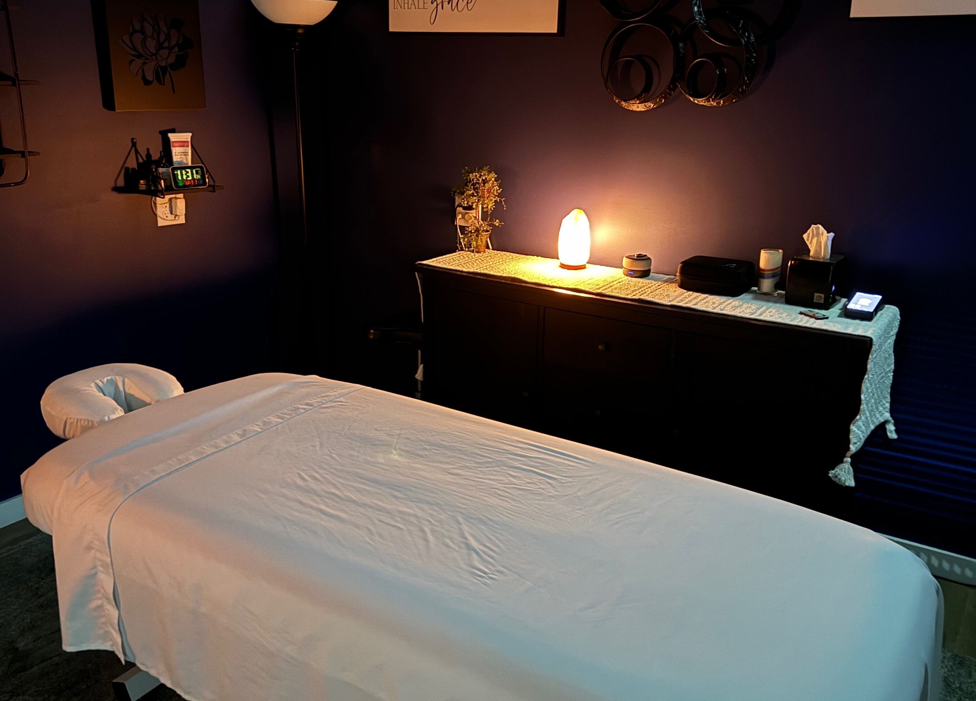 Relaxing massage room at Serenity Massage in Winchester, Virginia, US, featuring a cozy bed and ambient lighting.