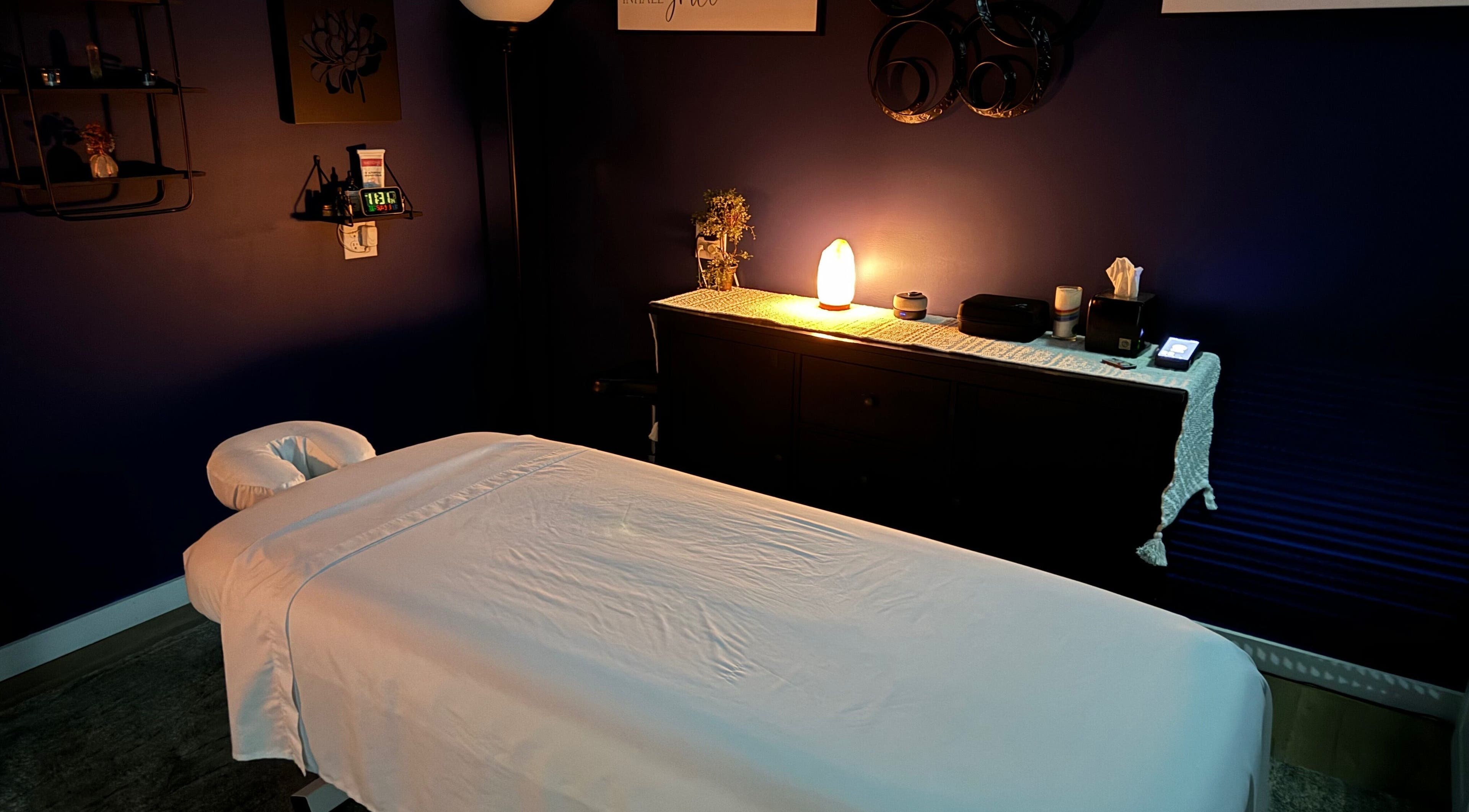 Relaxing massage room at Serenity Massage in Winchester, Virginia, US, featuring a cozy bed and ambient lighting.