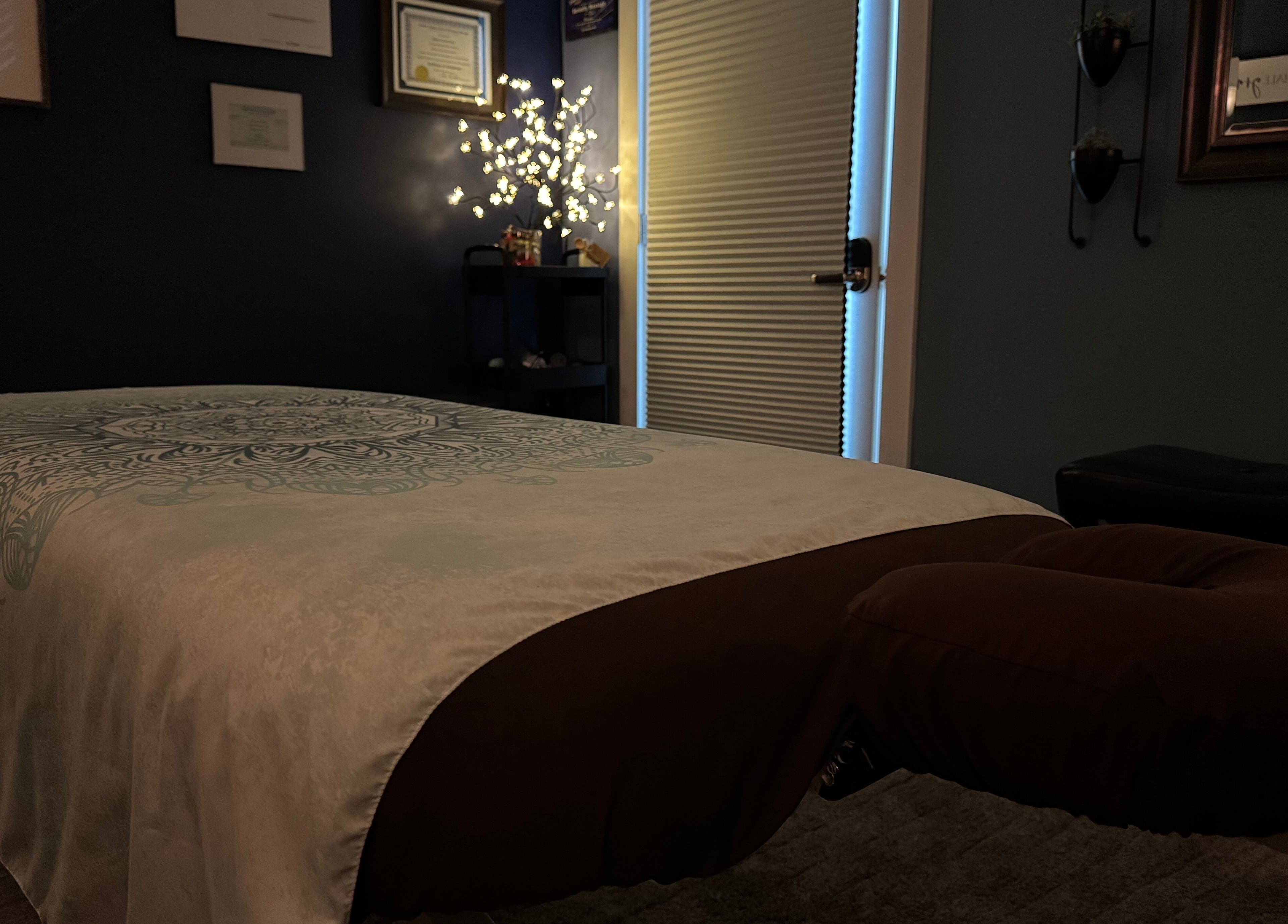 Serenity Massage room in Winchester, Virginia, US with a cozy massage table and soft lighting.