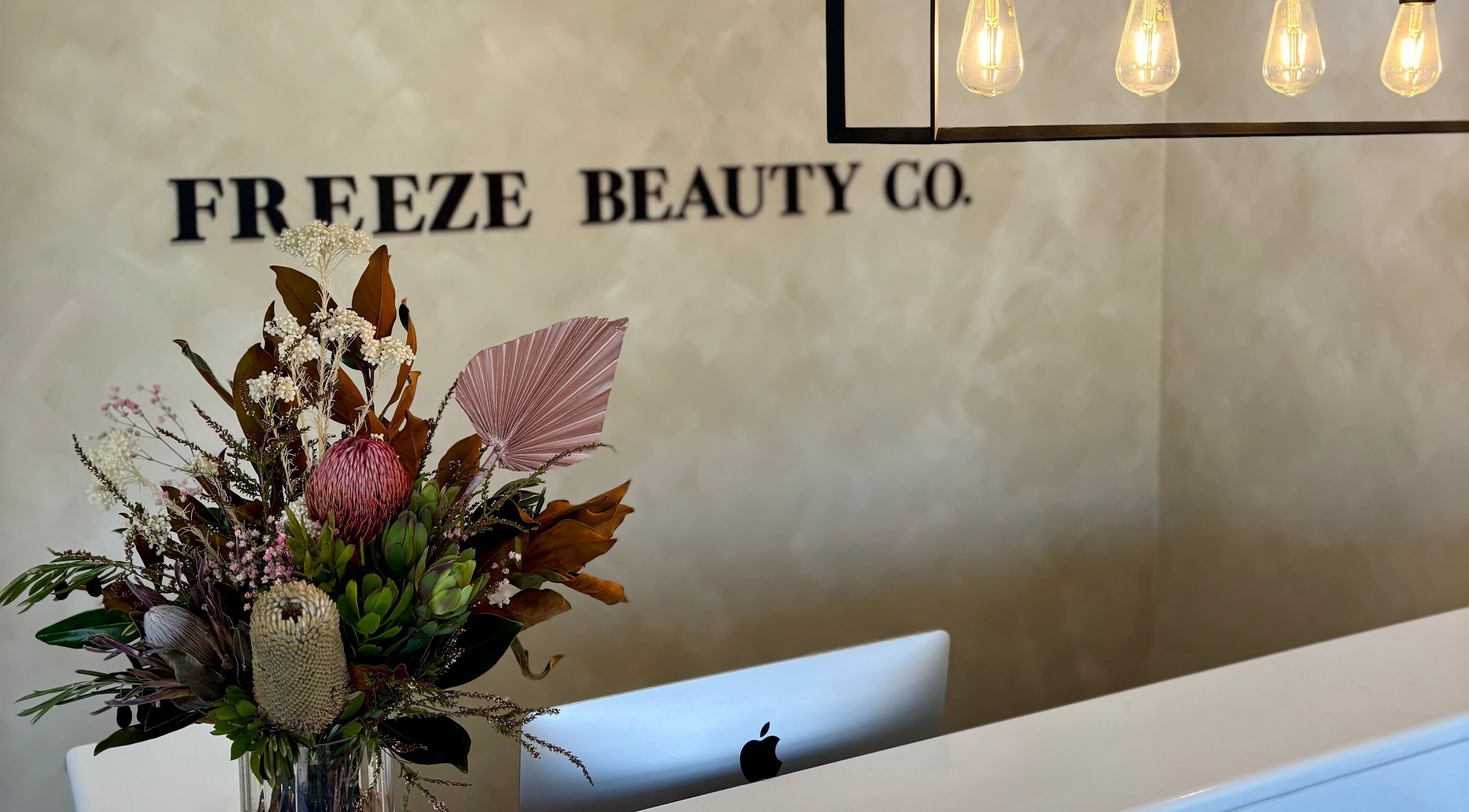 Reception area at Freeze Beauty Co. Bulimba featuring a floral arrangement, Bulimba, Queensland, AU.