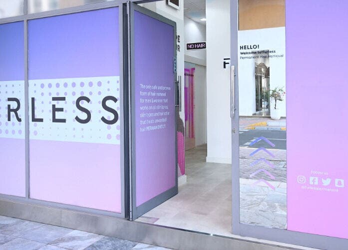 Furless Permanent Muroor Road entrance with vibrant purple decor in Abu Dhabi, AE.