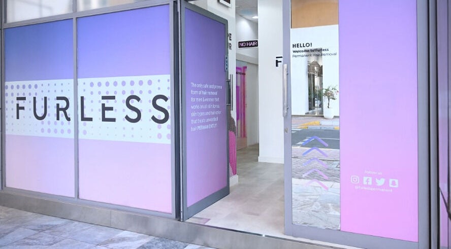 Furless Permanent Muroor Road entrance with vibrant purple decor in Abu Dhabi, AE.