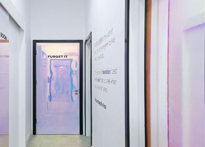 Modern hallway at Furless Permanent Muroor Road Abu Dhabi, AE, featuring pastel doors and sleek design.