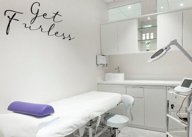 Modern treatment room at Furless Permanent Al Quoz, Dubai, AE, featuring electrolysis equipment and stylish decor.