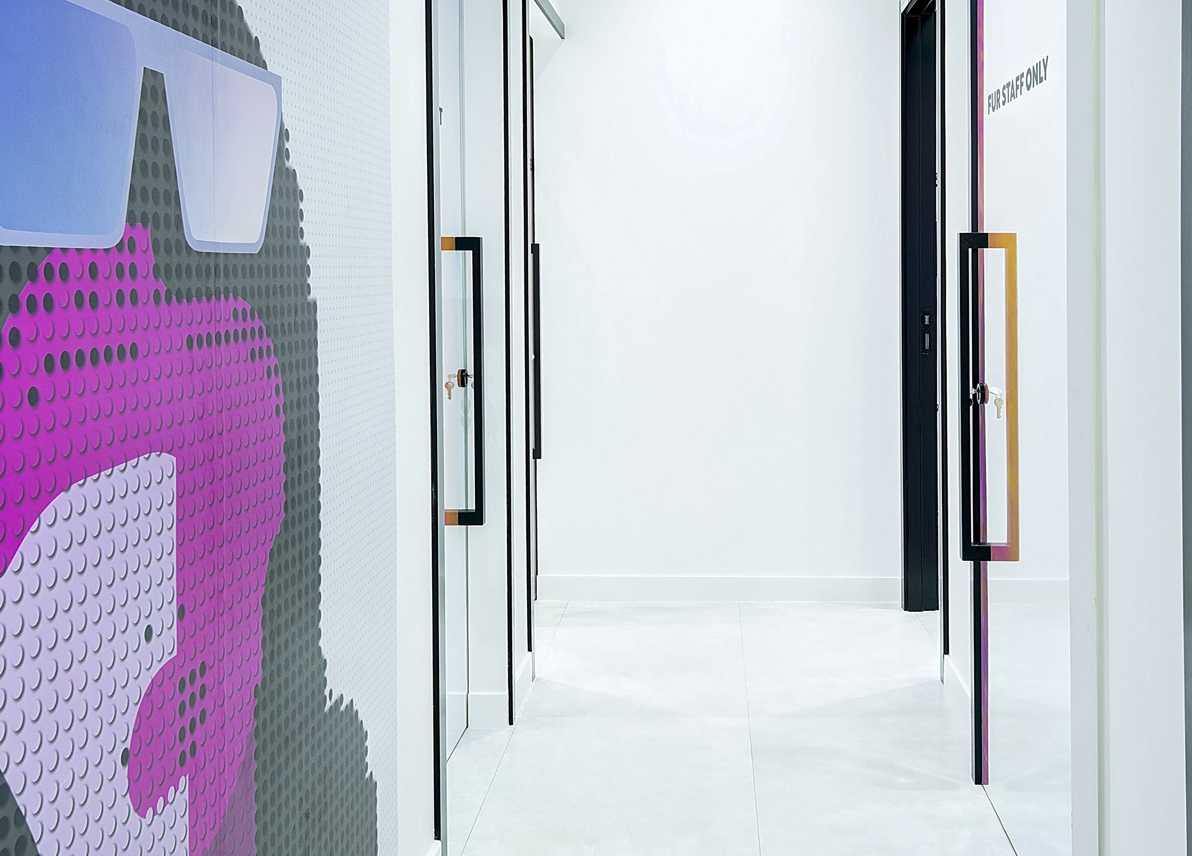 Modern hallway with vibrant art at Furless Permanent Rabdan Mall in Abu Dhabi, Abu Dhabi, AE.