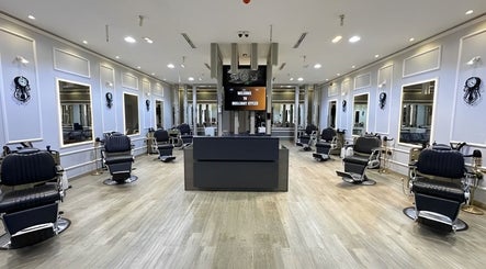 Spacious interior of BRILLIANT STYLES GENTS SALON in Al Barsha, Dubai, showcasing stylish barbershop seating.