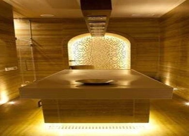 Relaxing spa room at BRILLIANT STYLES GENTS SALON - SPA, Al Barsha 1 Dubai, featuring warm golden lighting.