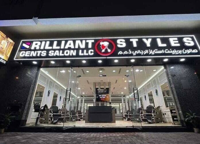 Brilliant Styles Gents Salon entrance in دبي Dubai, AE, illuminated sign with glass doors.