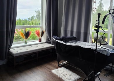Tranquil treatment room at Looks by Lew, Maple Ridge, British Columbia, CA with a view of lush greenery.