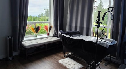Tranquil treatment room at Looks by Lew, Maple Ridge, British Columbia, CA with a view of lush greenery.