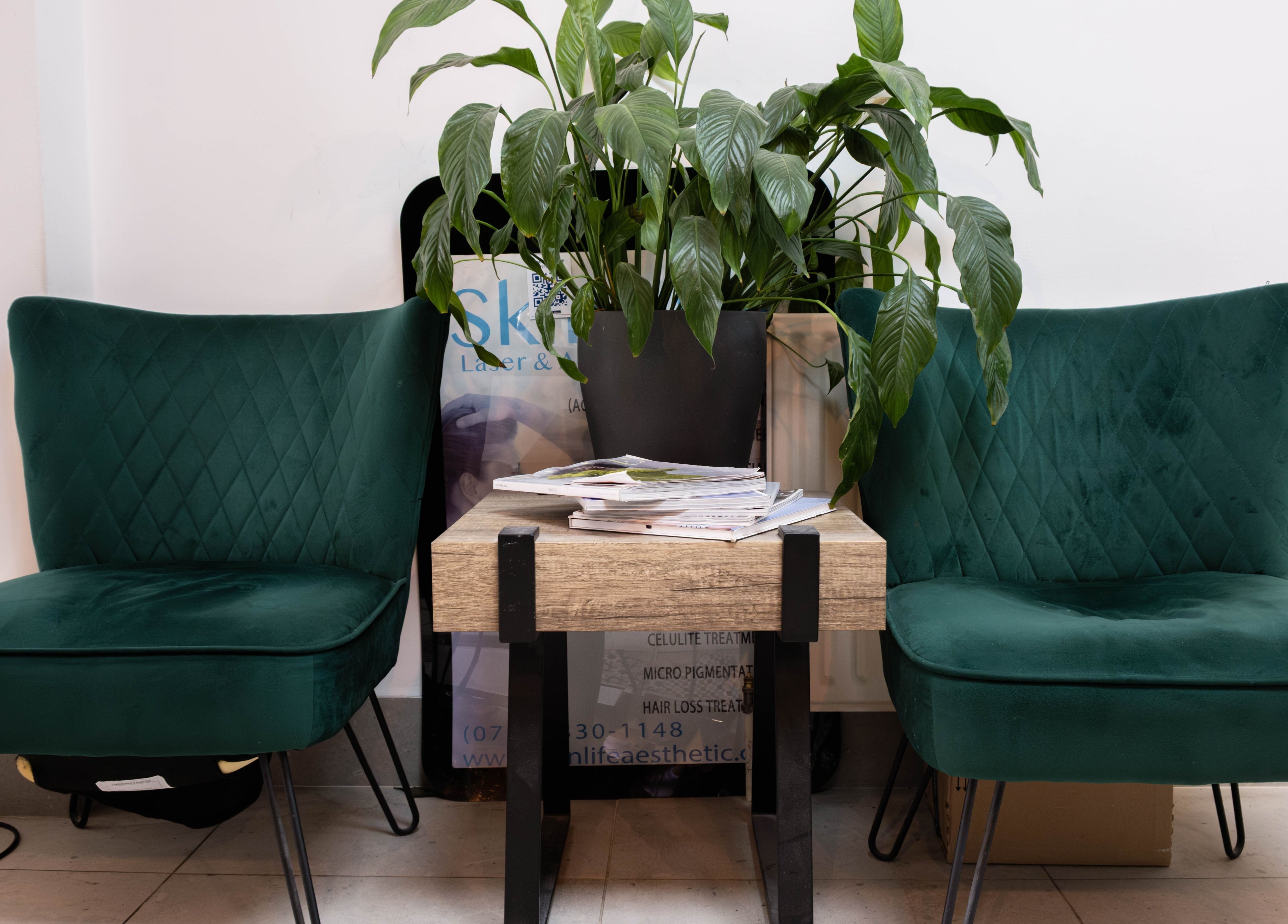 Cozy green chairs in reception area at Viktoria Pereviazko Professional Nails Artist, London, England, GB.