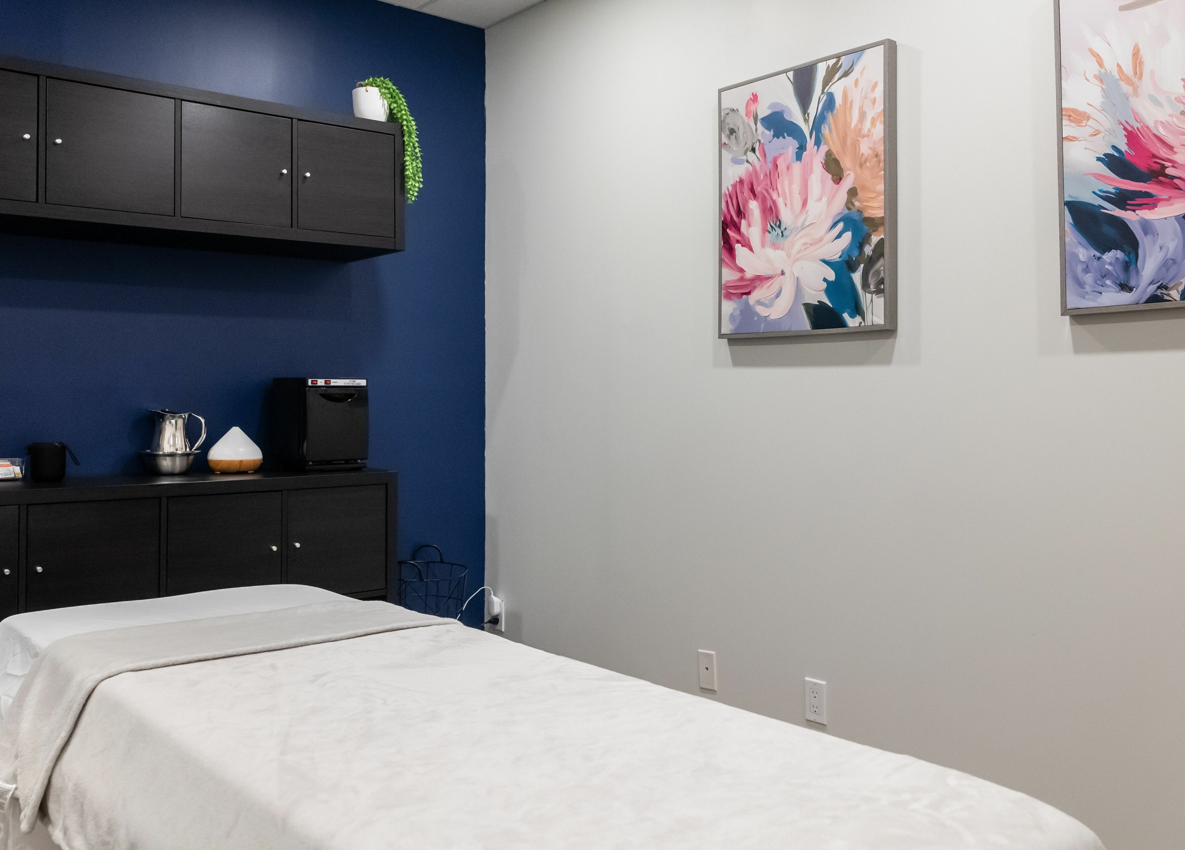 Massage room at Melt Body Health, Windsor, Ontario, CA shows serene decor and massage table.