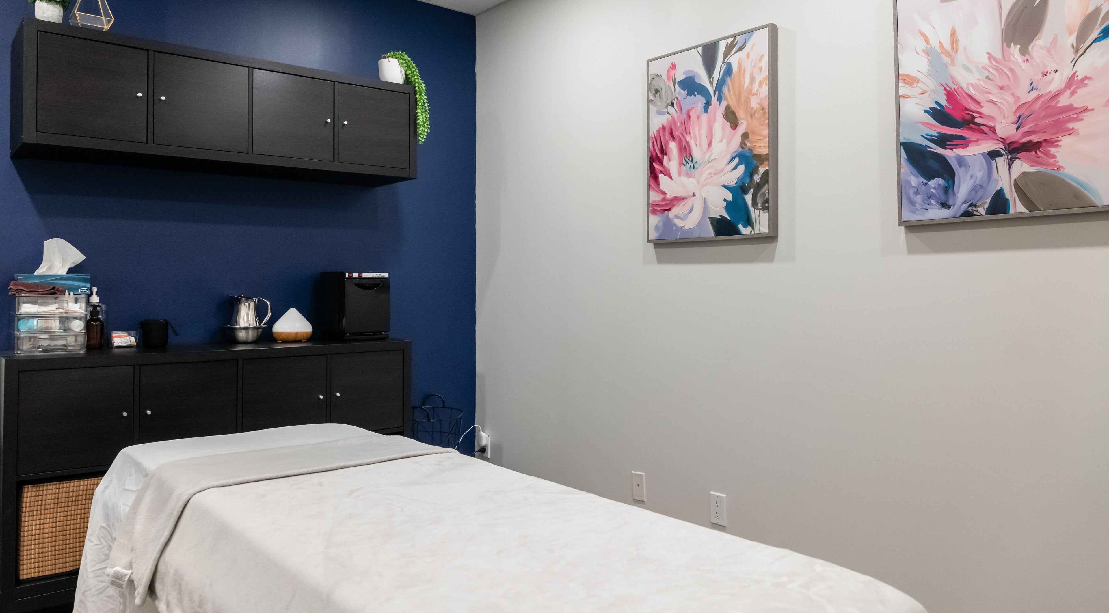Massage room at Melt Body Health, Windsor, Ontario, CA shows serene decor and massage table.