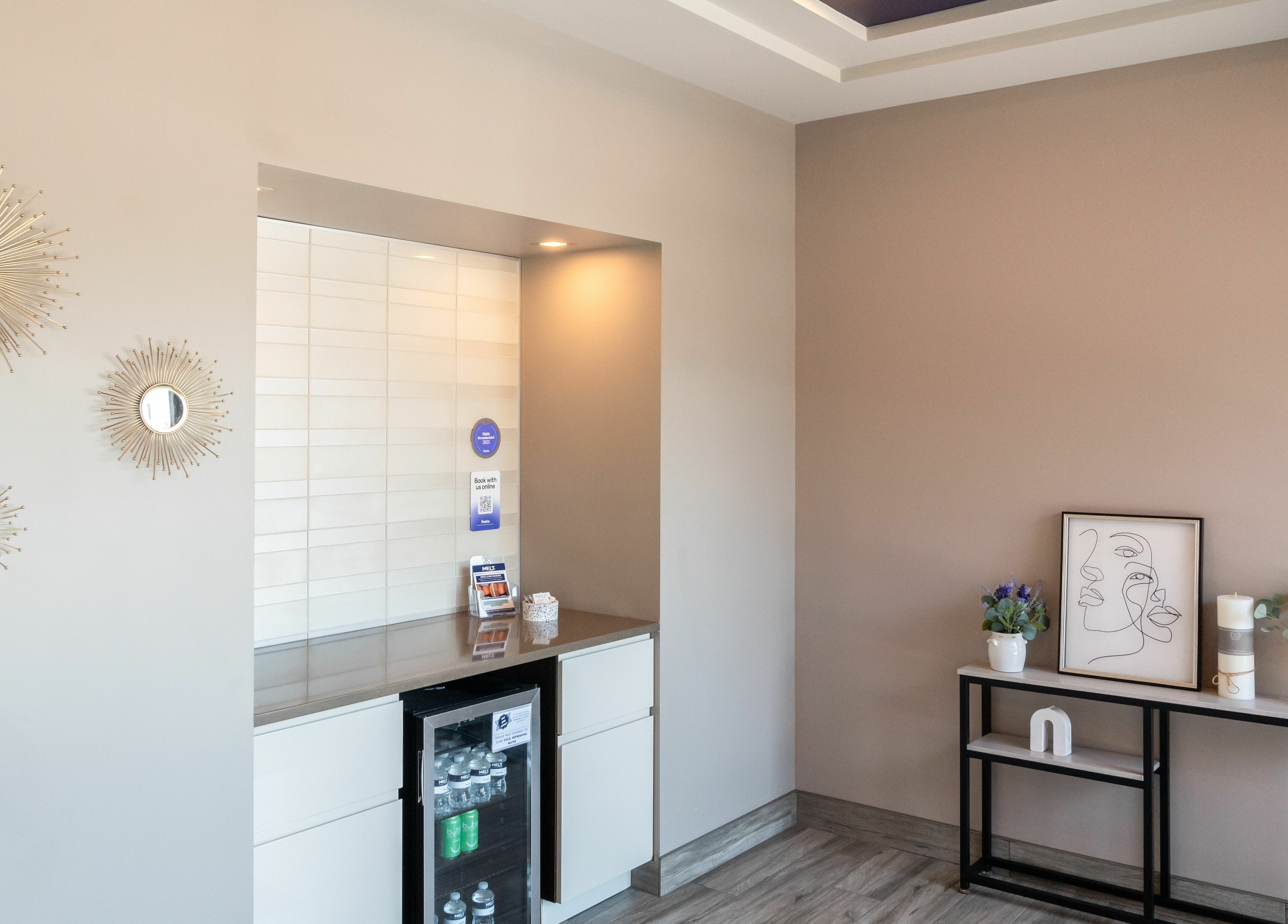 Elegant decor at Melt Body Health in Windsor, Ontario, CA featuring modern art, plants, and stylish mirrors.