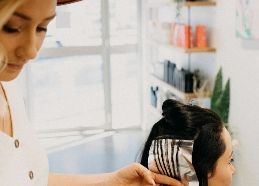 Stylist at The Color Room Glenbrook highlights client's hair in Glenbrook, New South Wales, AU salon.