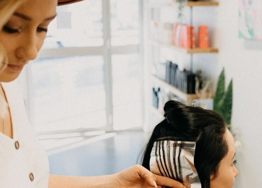 Stylist at The Color Room Glenbrook highlights client's hair in Glenbrook, New South Wales, AU salon.